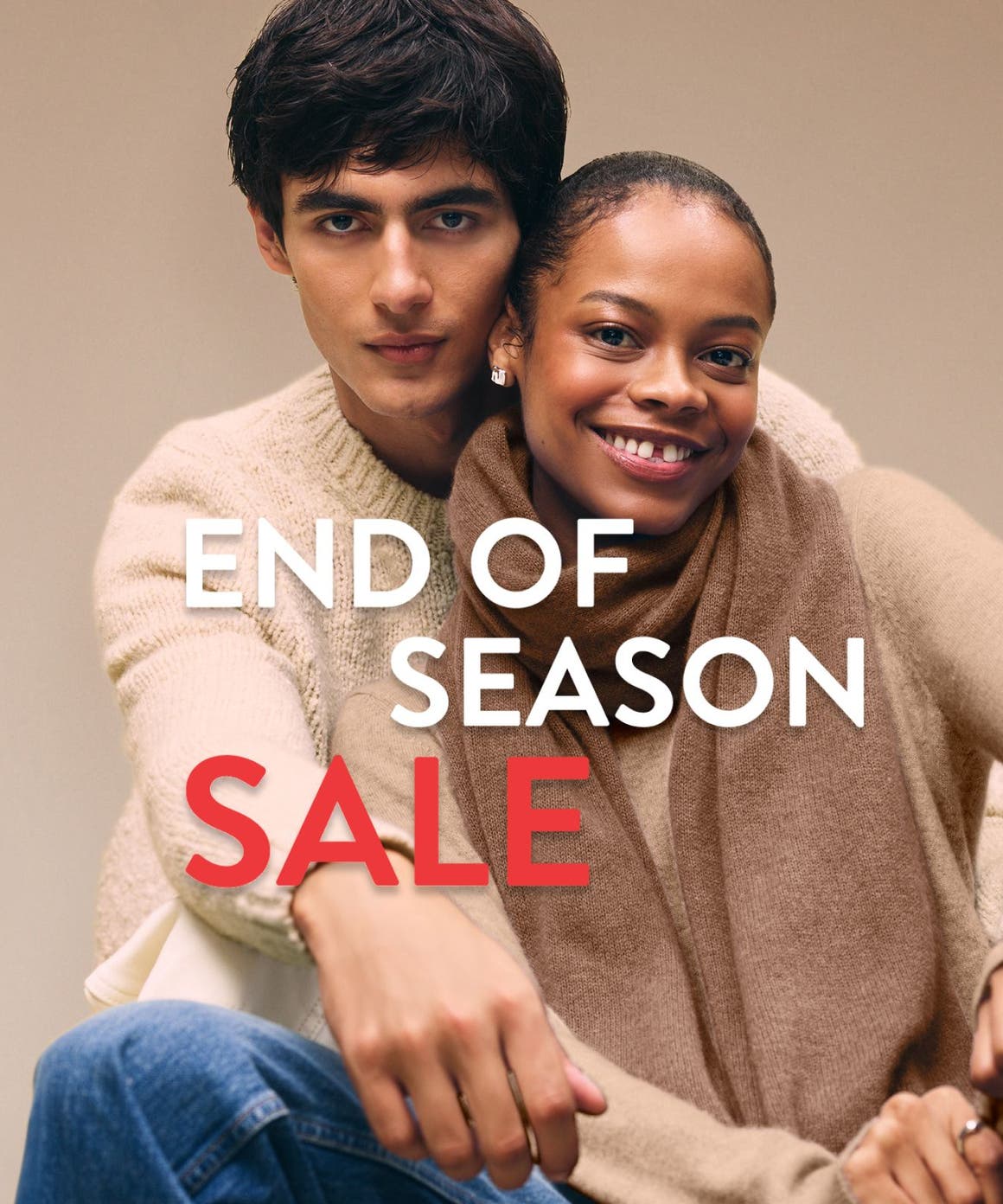 End-of-season sale. A woman and man wearing cozy knitwear.