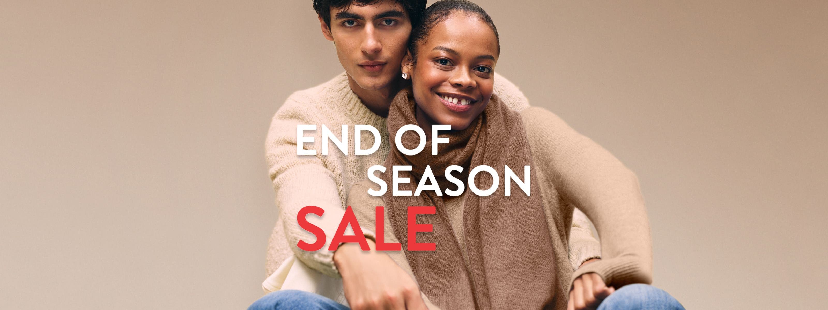 End-of-season sale. A woman and man wearing cozy knitwear.