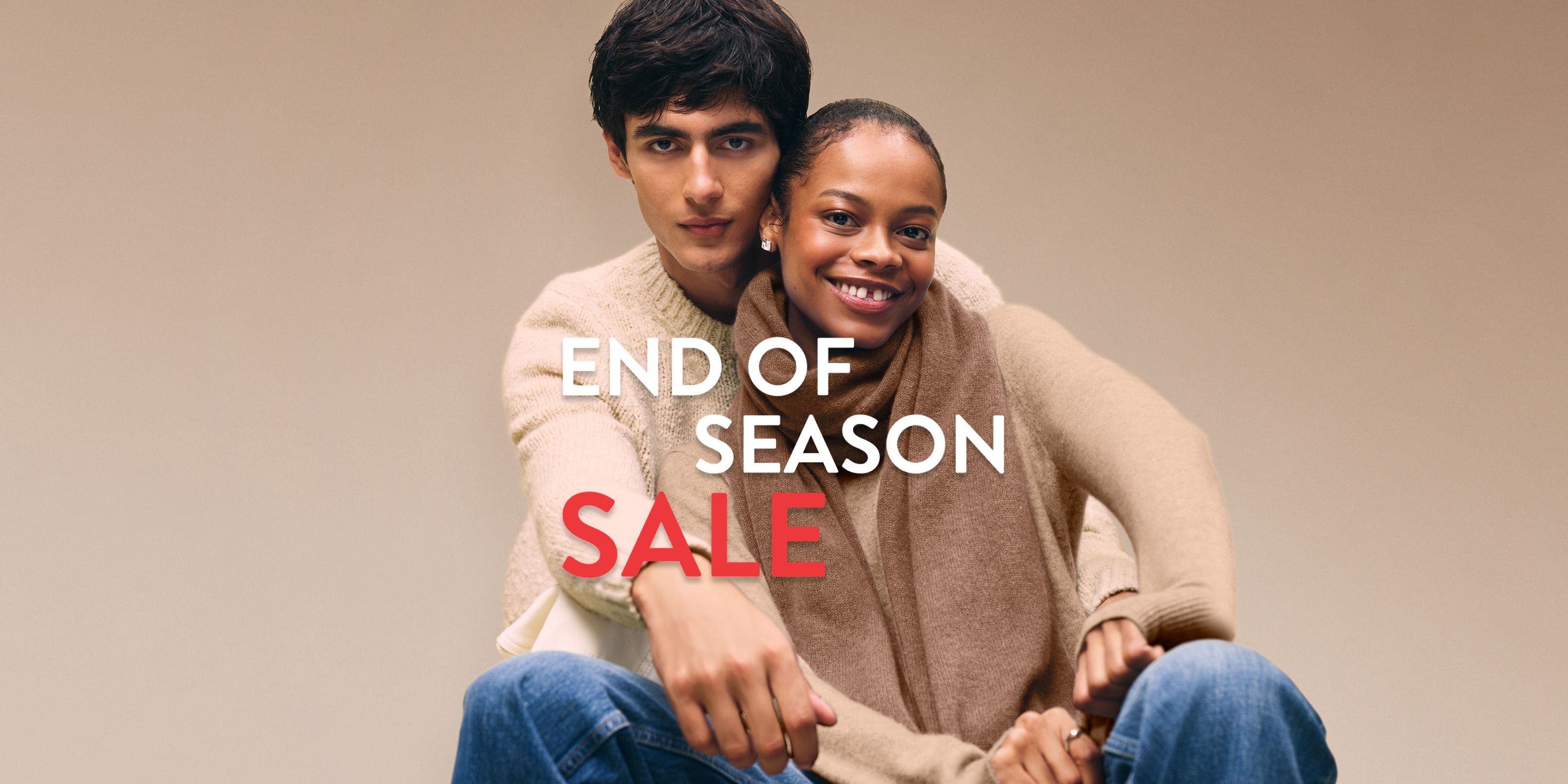 End-of-season sale. A woman and man wearing cozy knitwear.