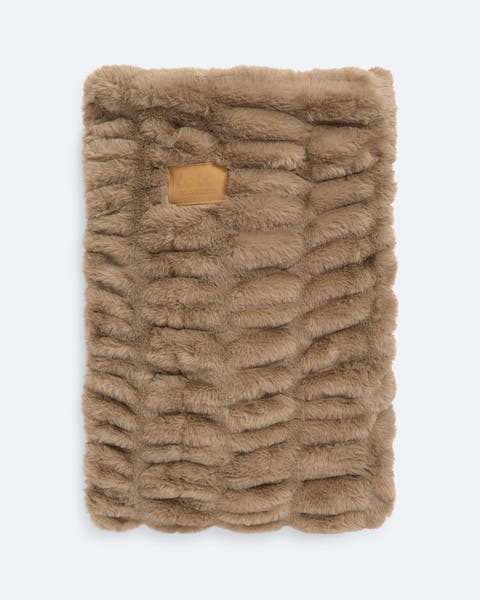 A tan faux fur blanket.