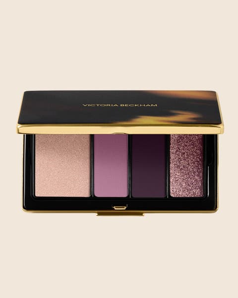 A Victoria Beckham eyeshadow palette with four shades in nude, mauve and plum.