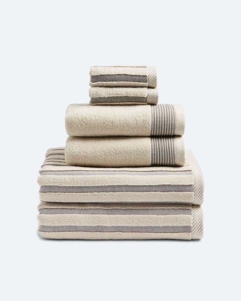A stack of neutral stiped bath towels.