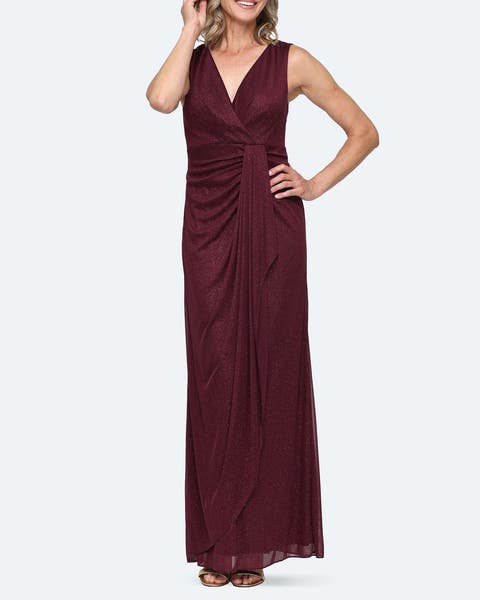 A woman wearing a sleek burgundy v-neck gown.