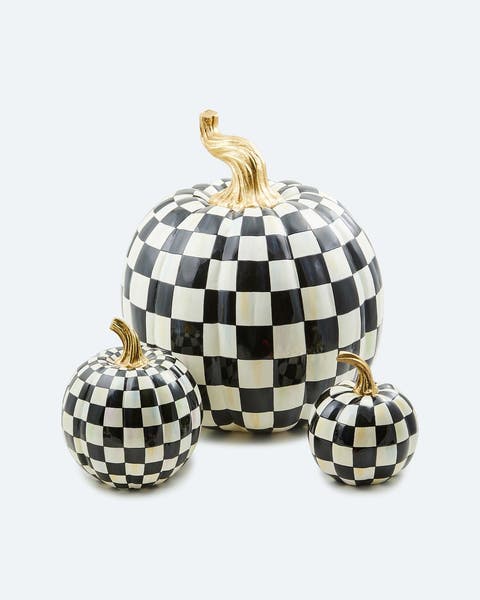A trio of black and white checkered Mackenzie-Childs pumpkins.