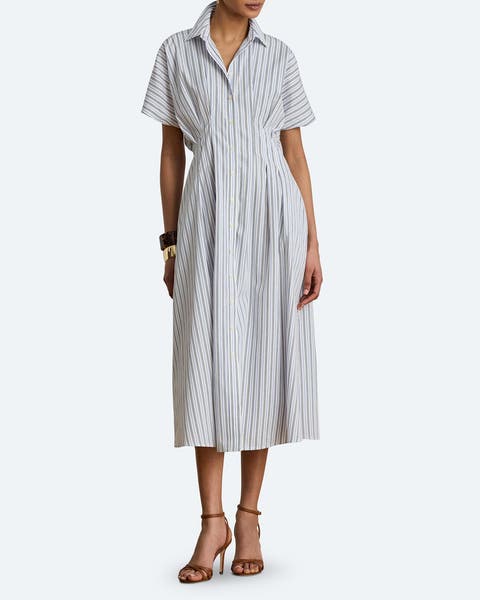 A woman in a stripped linen shirt dress.