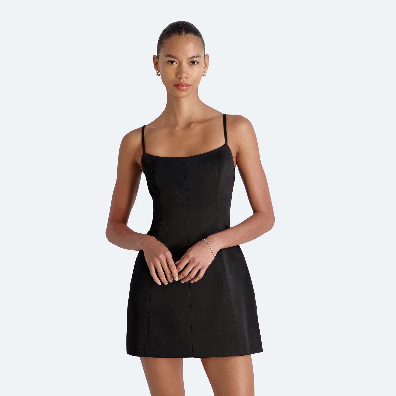 A woman wearing a semi-formal black mini dress.