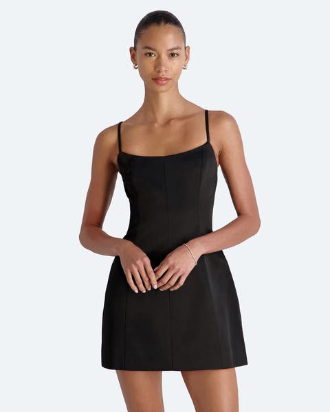 A woman wearing a semi-formal black mini dress.