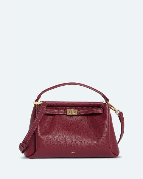 Burgundy pebbled leather top-handle bag with a gold turn-lock closure.
