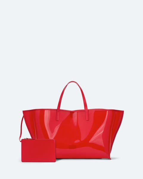 Red patent tote bag with a matching zip pouch.