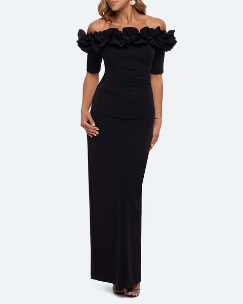 A woman wearing black off the shoulder ruffle trim long gown.