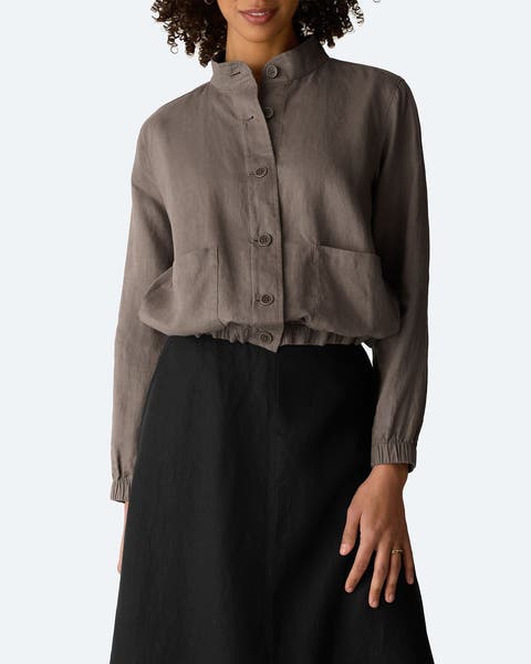 A woman in a grey button-up jacket.