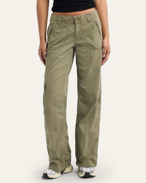 A woman wearing a pair of green cargo pants.