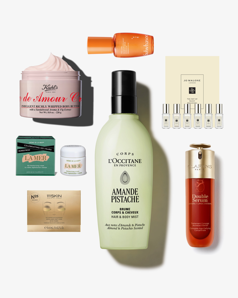 L'Occitane Amande Pêche bottle surrounded by skincare jars, serums and fragrance vials.