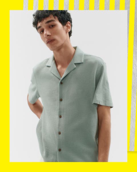 A man wearing a short-sleeve button-up shirt.