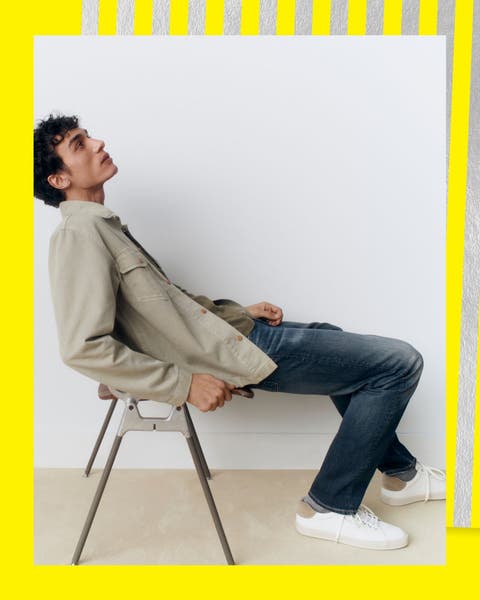 A man wearing a shirt and jeans.