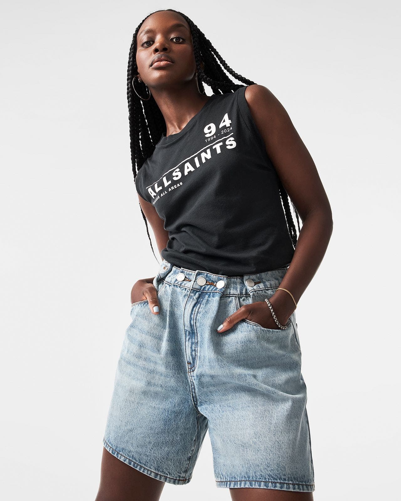 Woman wearing tee and denim shorts.