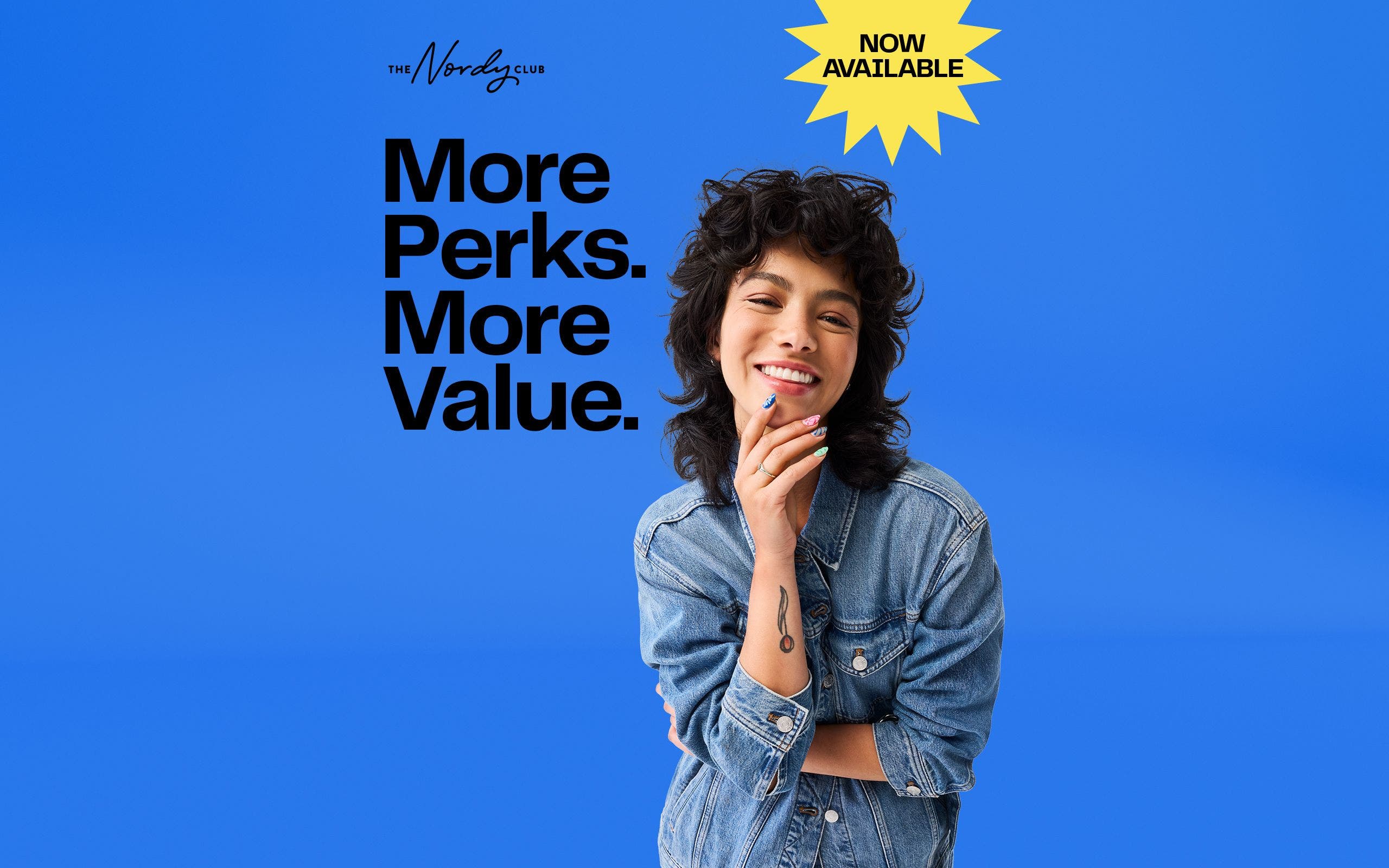 Now available: more perks, more value. A woman wearing a denim jacket.