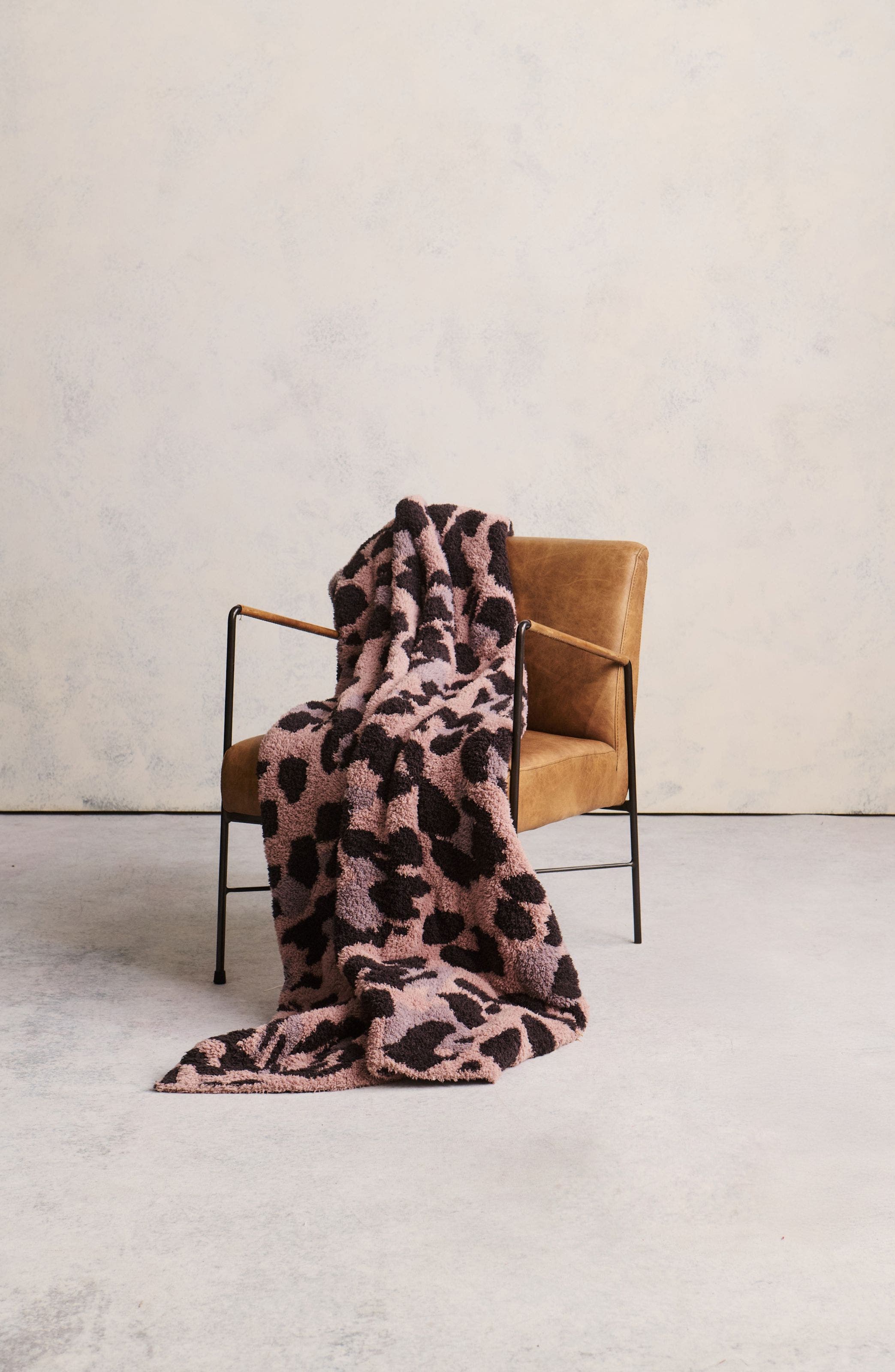An animal-print blanket draped over a chair.