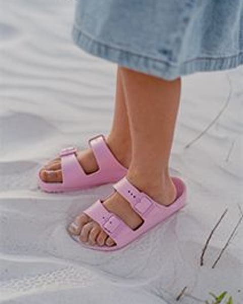 A kid wearing Birkenstock sandals.