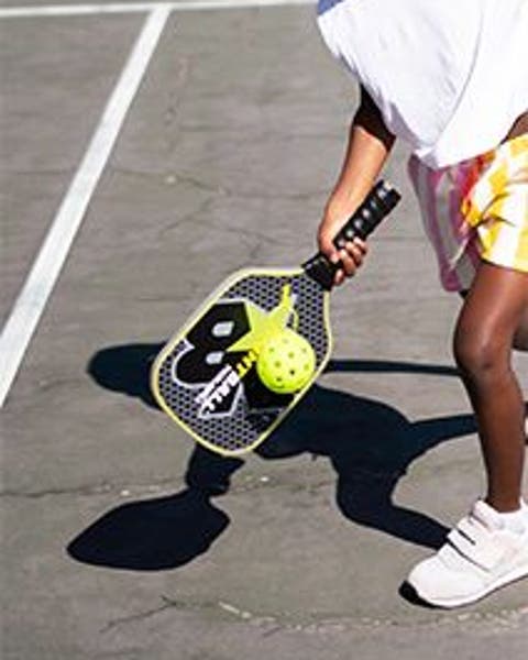 A girl playing pickleball.