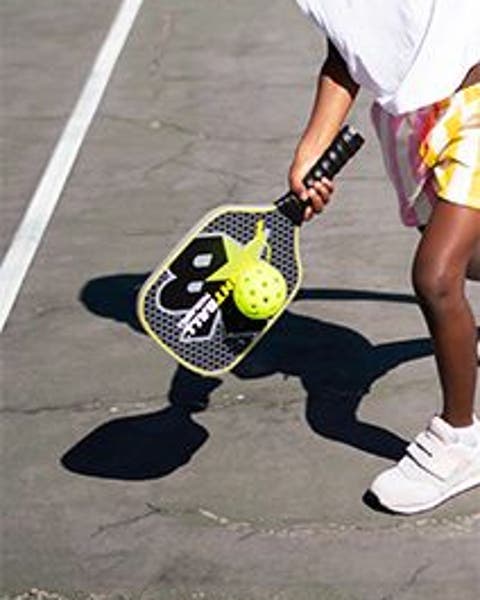 Little boy playing pickleball.
