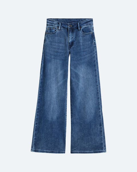 A pair of wide leg dark wash jeans for girls.