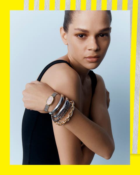 A woman wearing a slack of bracelets.
