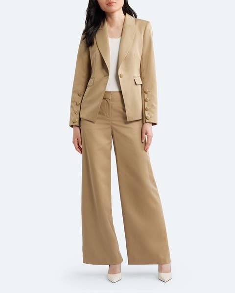 A woman wearing a tan suit.