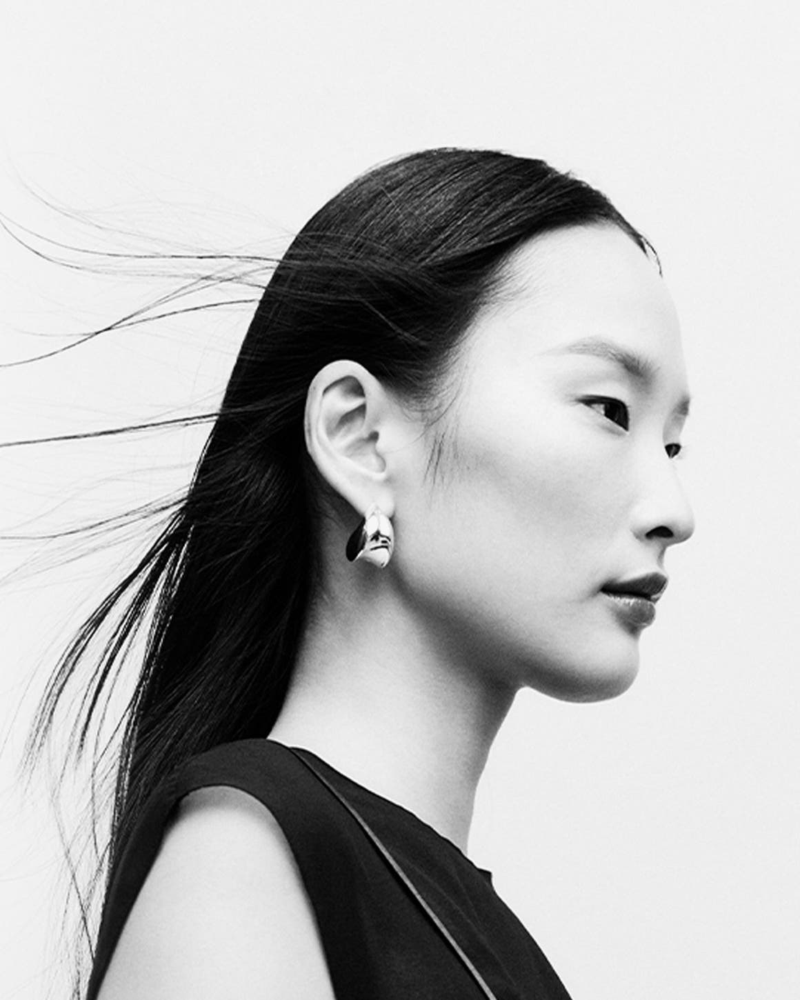 Woman wearing designer jewelry.