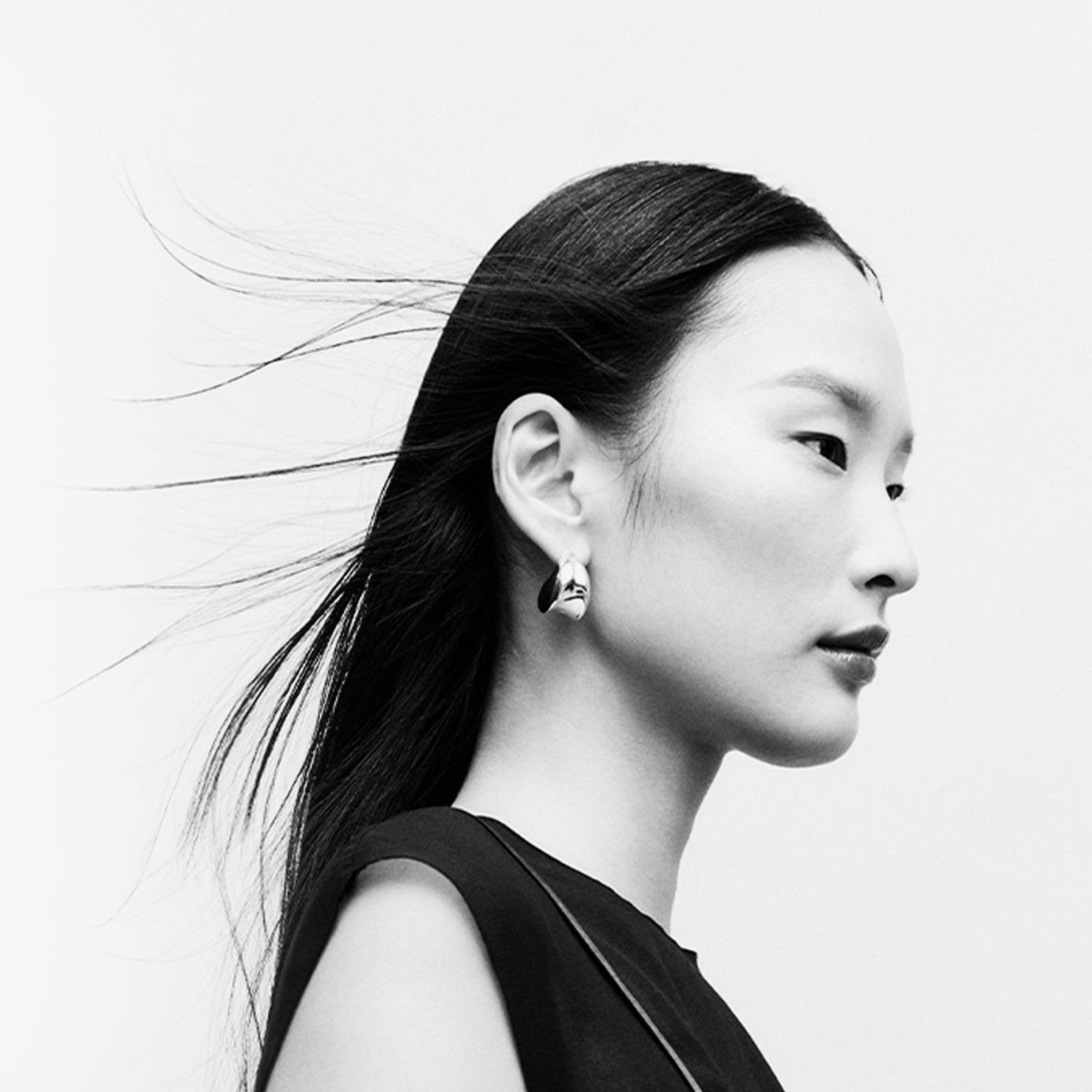 Woman wearing designer jewelry.
