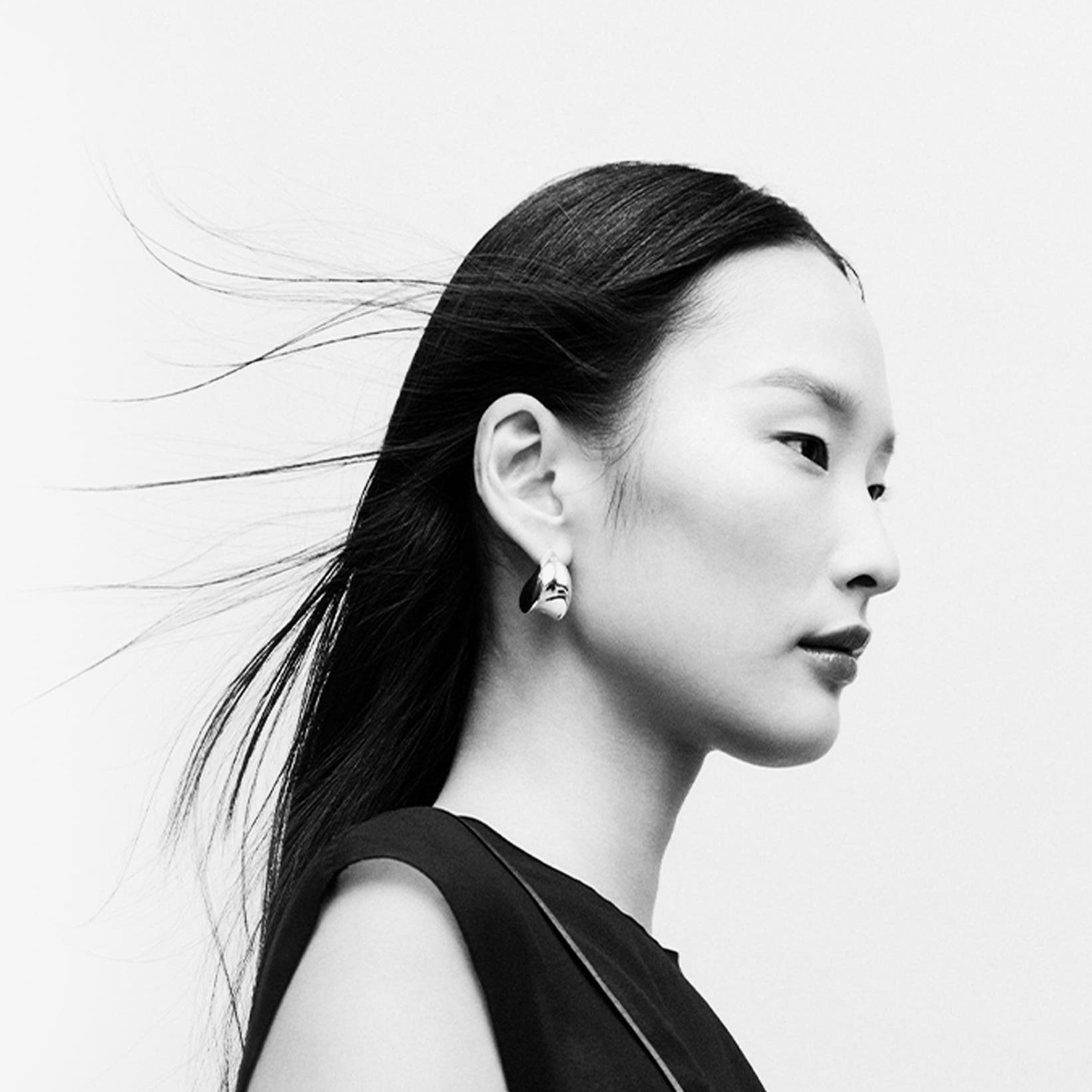 Woman wearing designer jewelry.