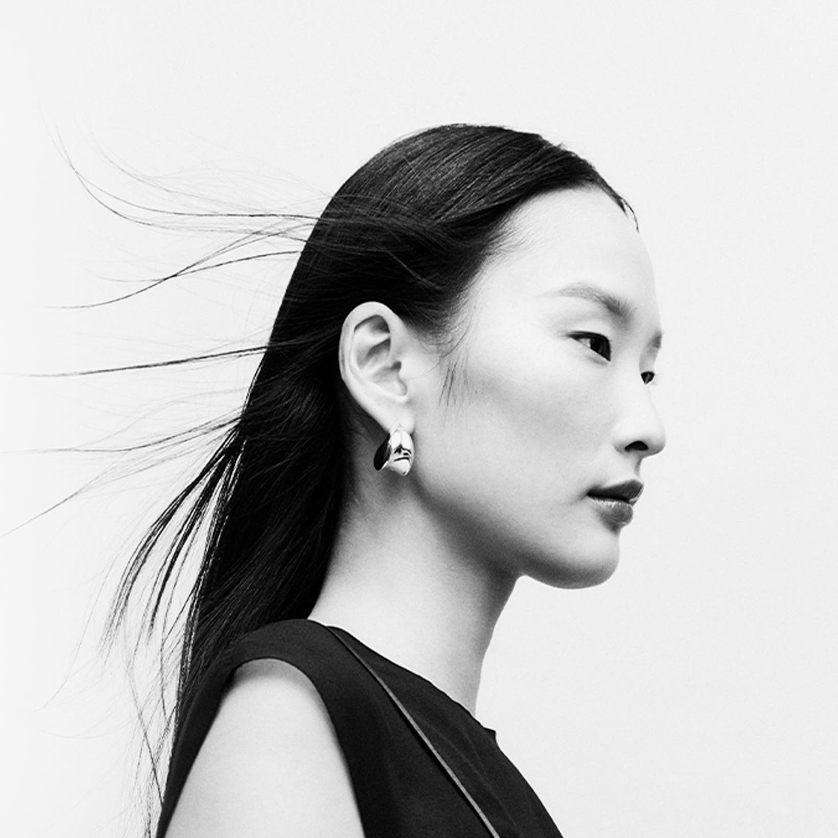 Woman wearing designer jewelry.