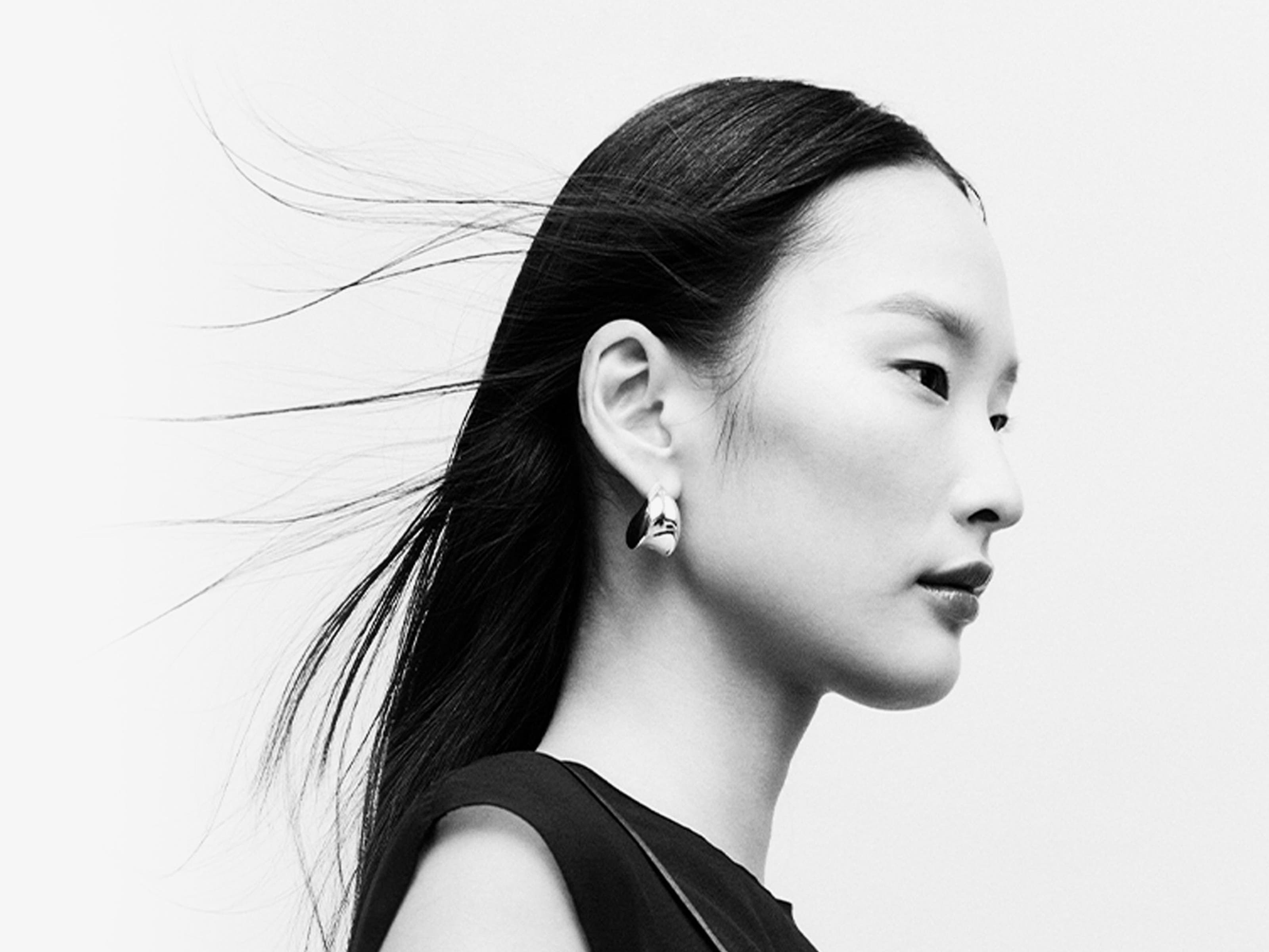 Woman wearing designer jewelry.