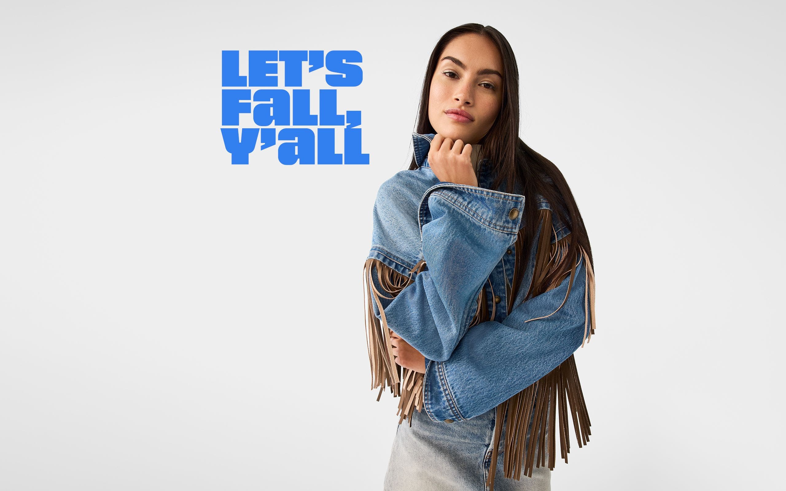 A woman wearing a fringed denim jacket.