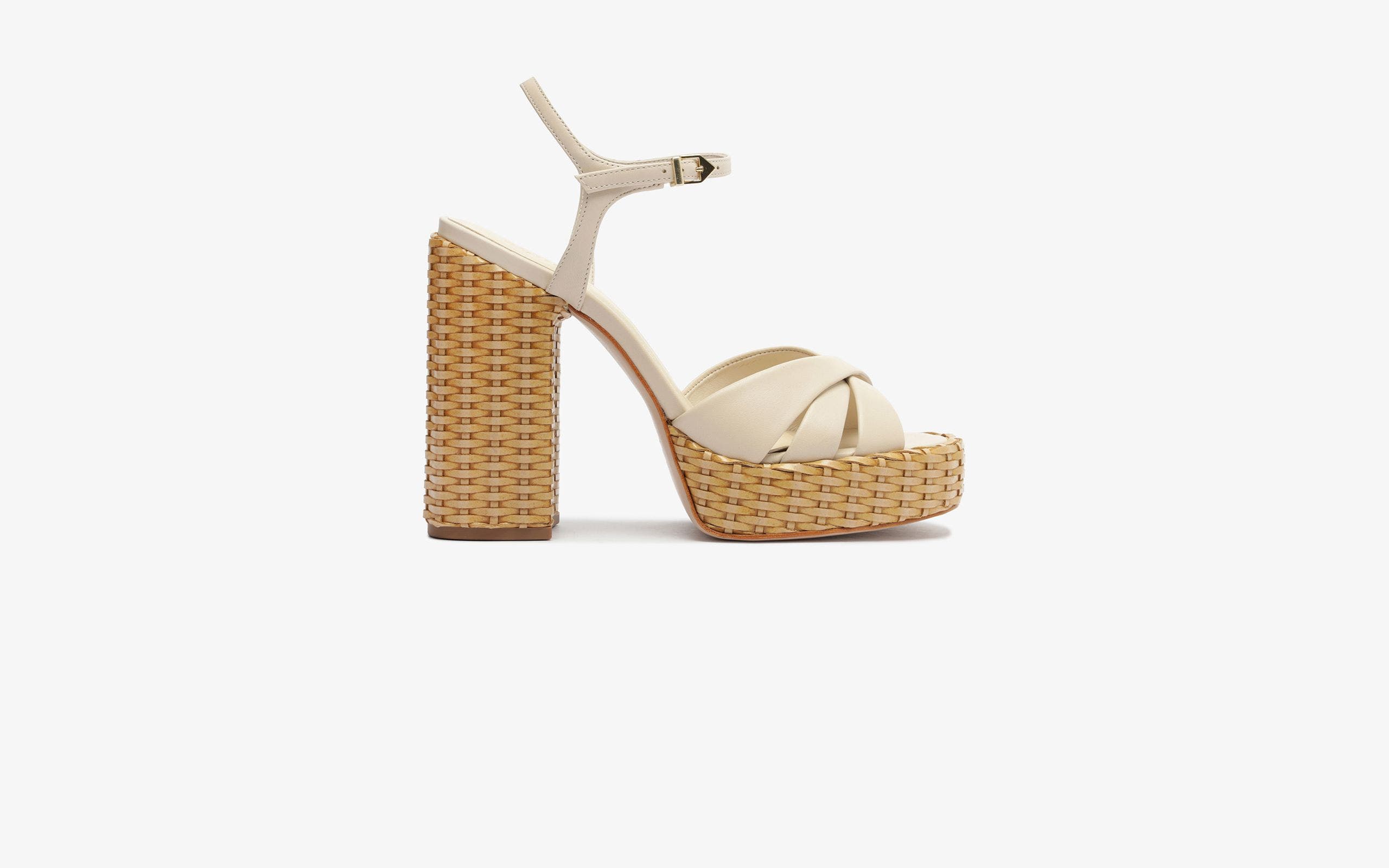 Cream sandals with woven platform heels.