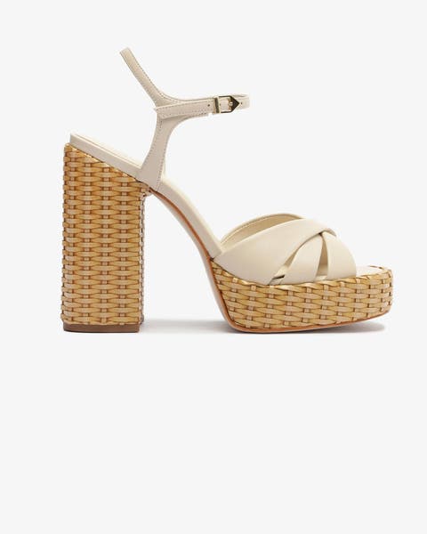 Cream sandals with woven platform heels.