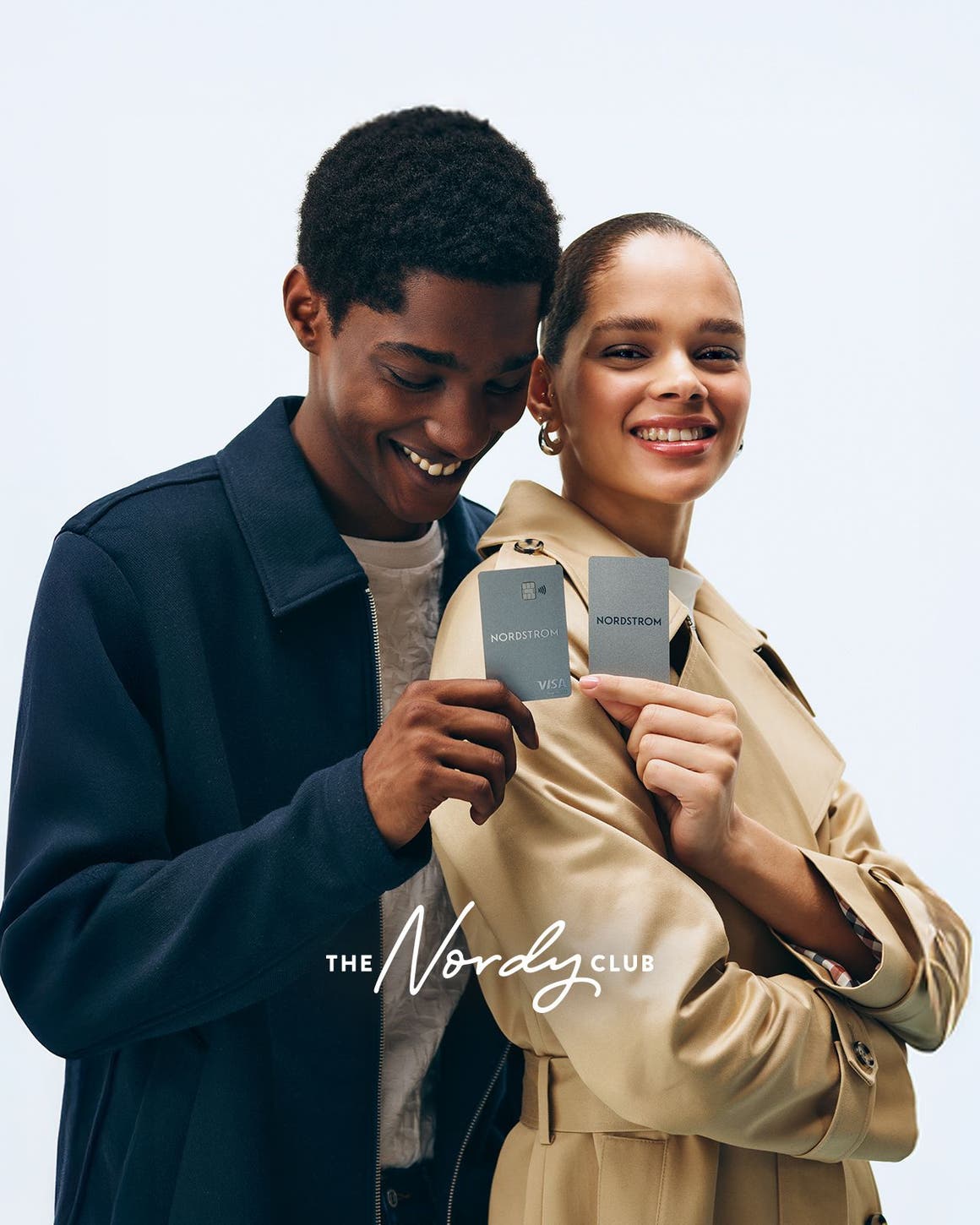 Man and woman holding Nordstrom credit card.