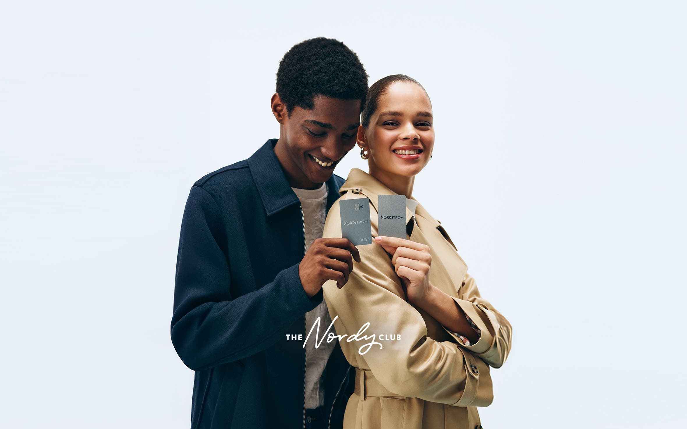 Man and woman holding Nordstrom credit card.