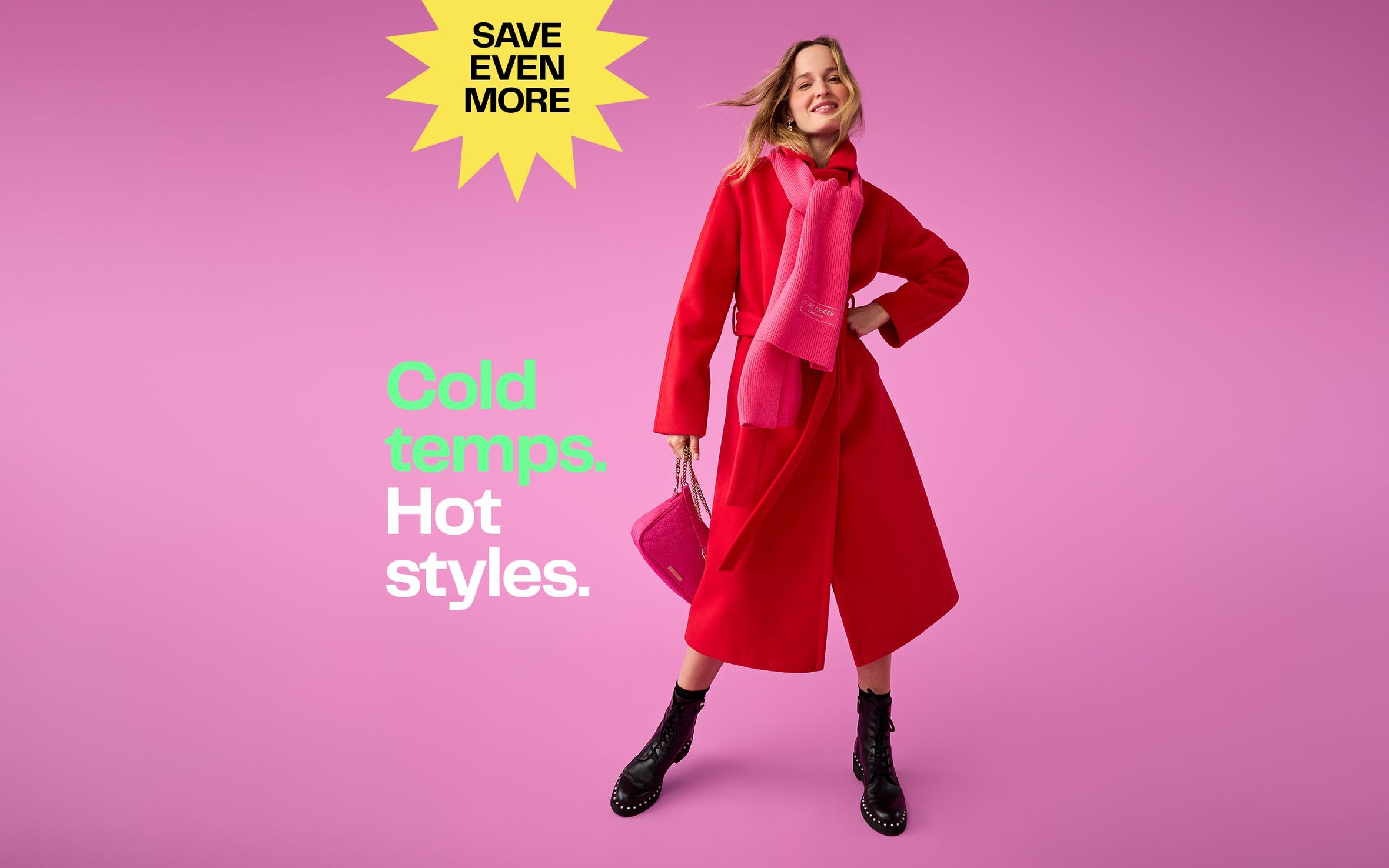 A woman wearing a red coat, pink scarf and black studded boots.