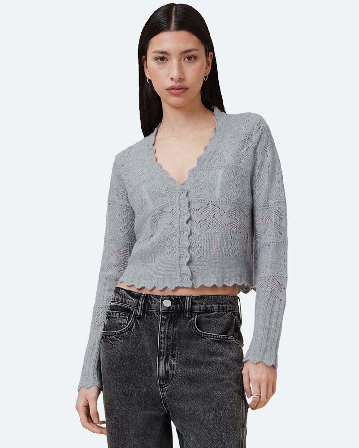 A woman in a cropped cardigan and black jeans from AllSaints. 