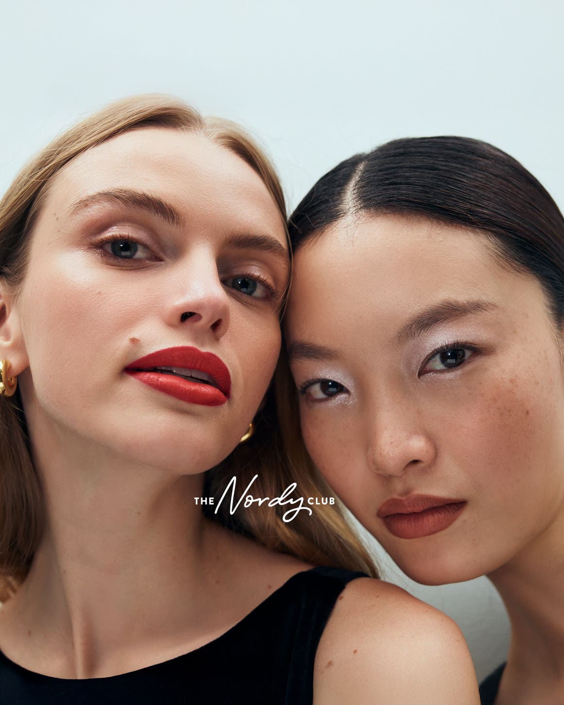 two women wearing makeup