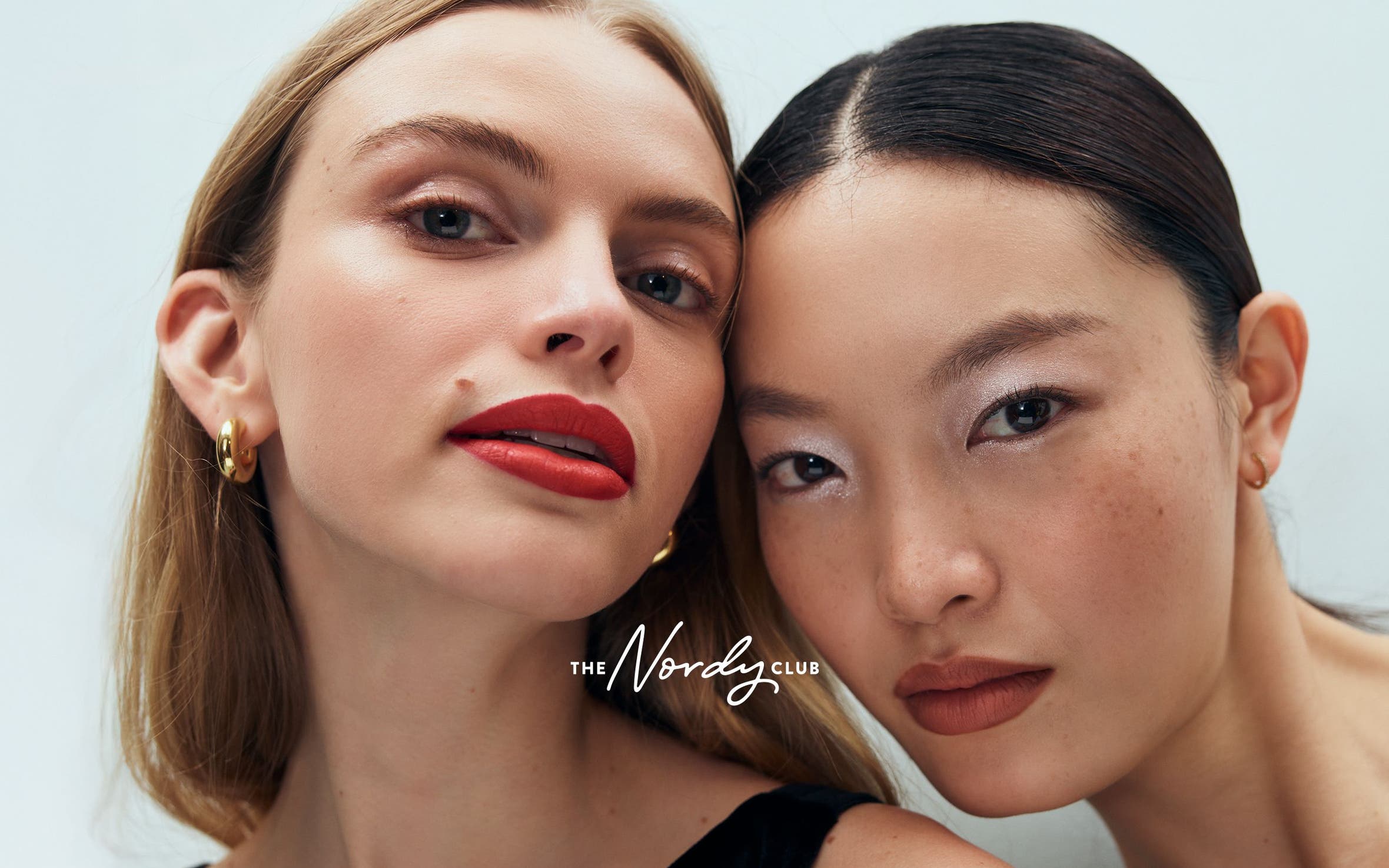 two women wearing makeup