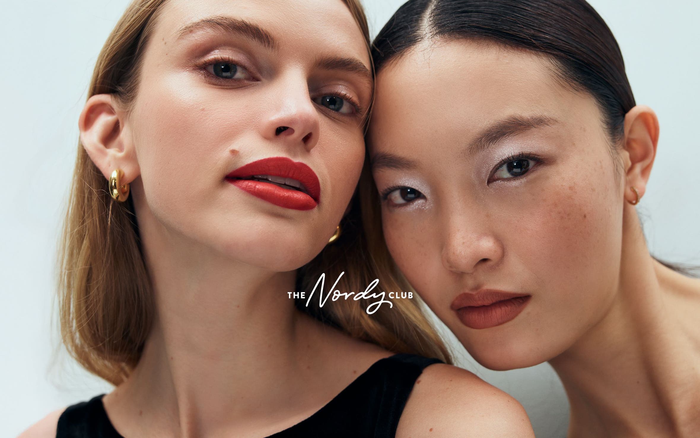 Two women with made-up faces.