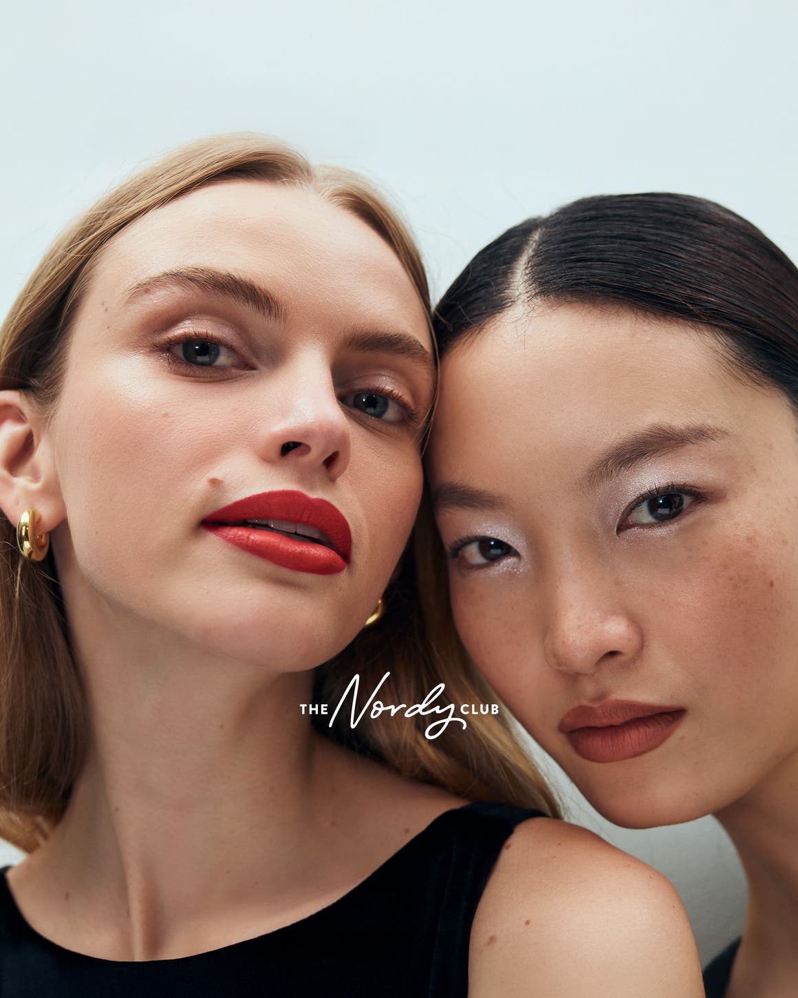 Two women with made-up faces.