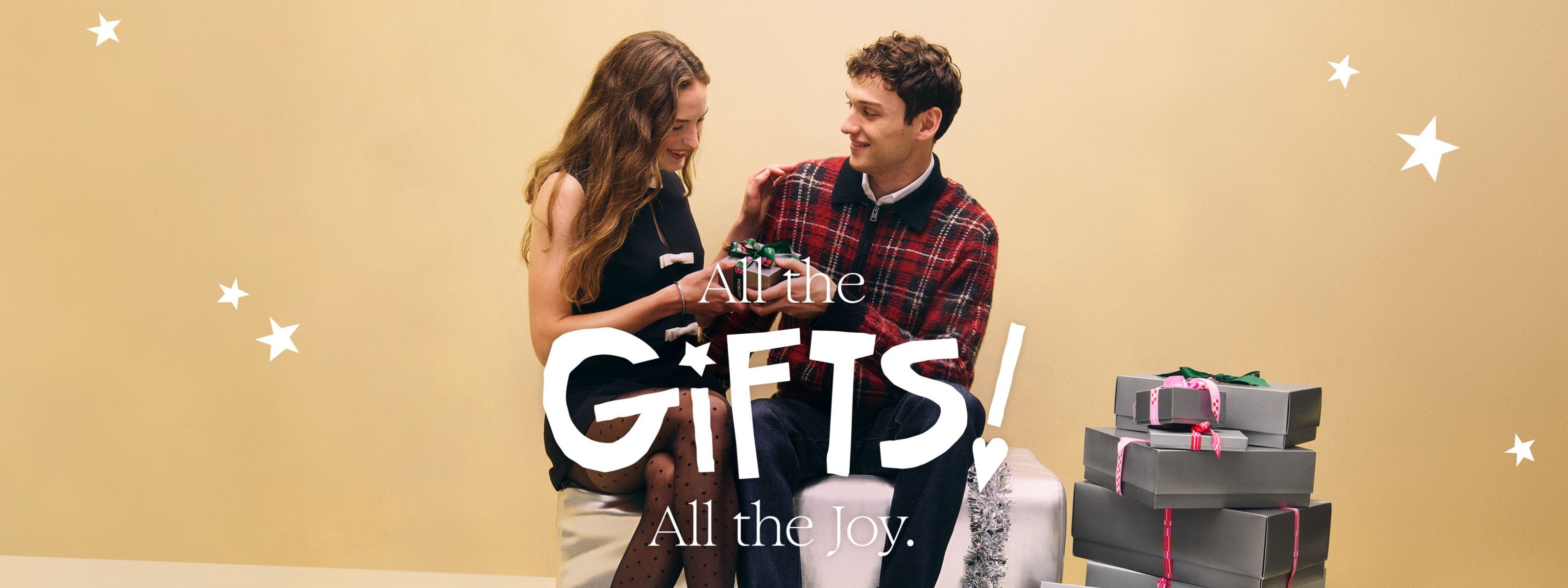 All the gifts, all the joy: a woman and man exchanging holiday gifts.