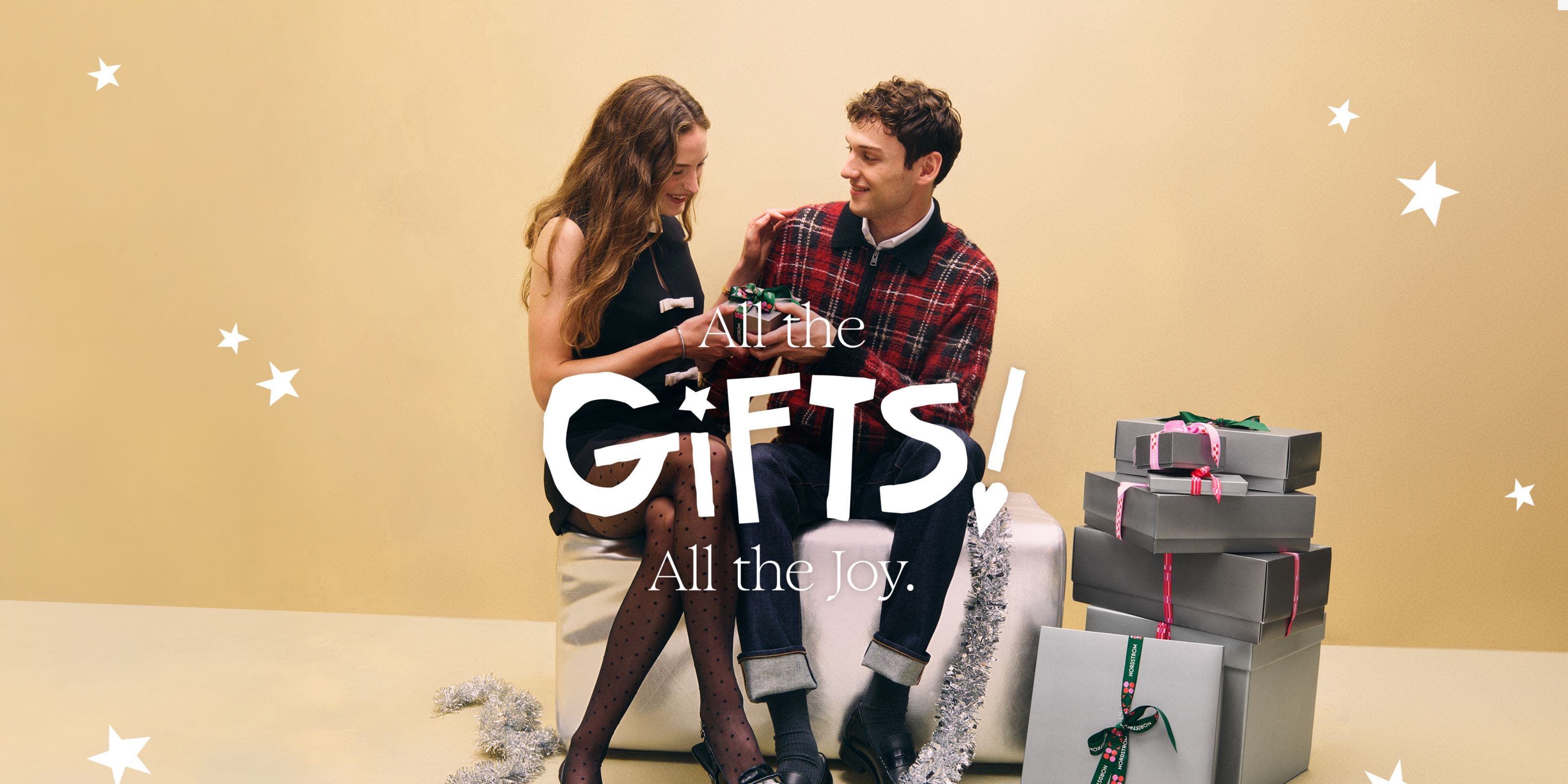 All the gifts, all the joy: a woman and man exchanging holiday gifts.