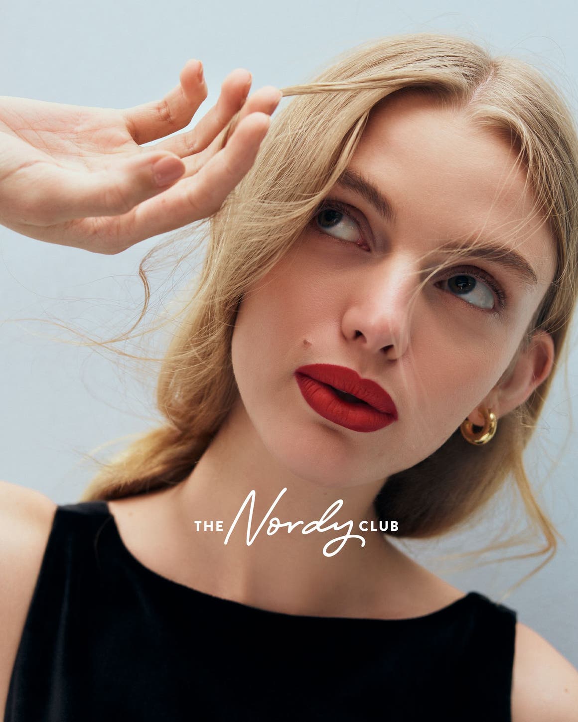 A woman wearing red lipstick.