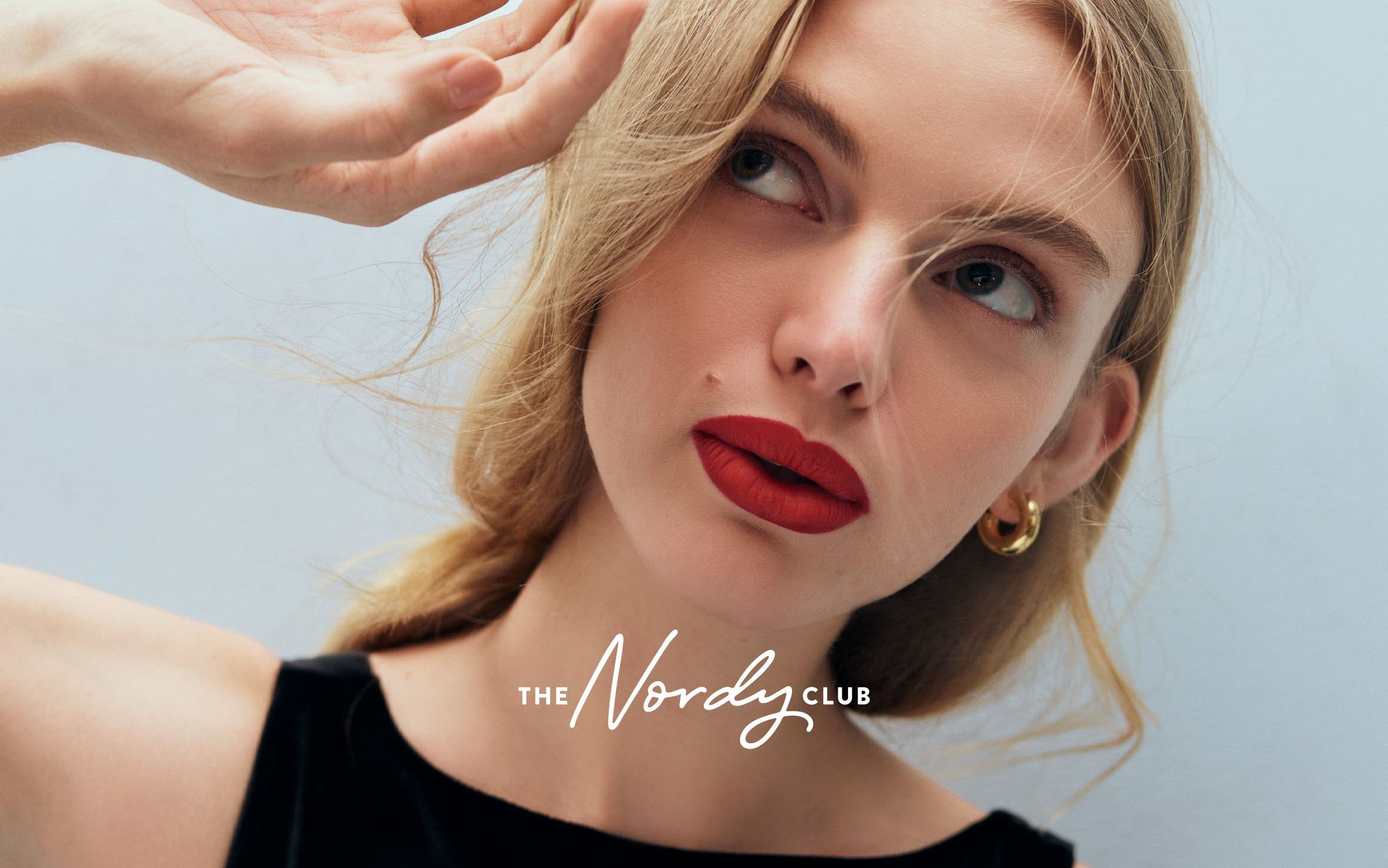 A woman wearing red lipstick.