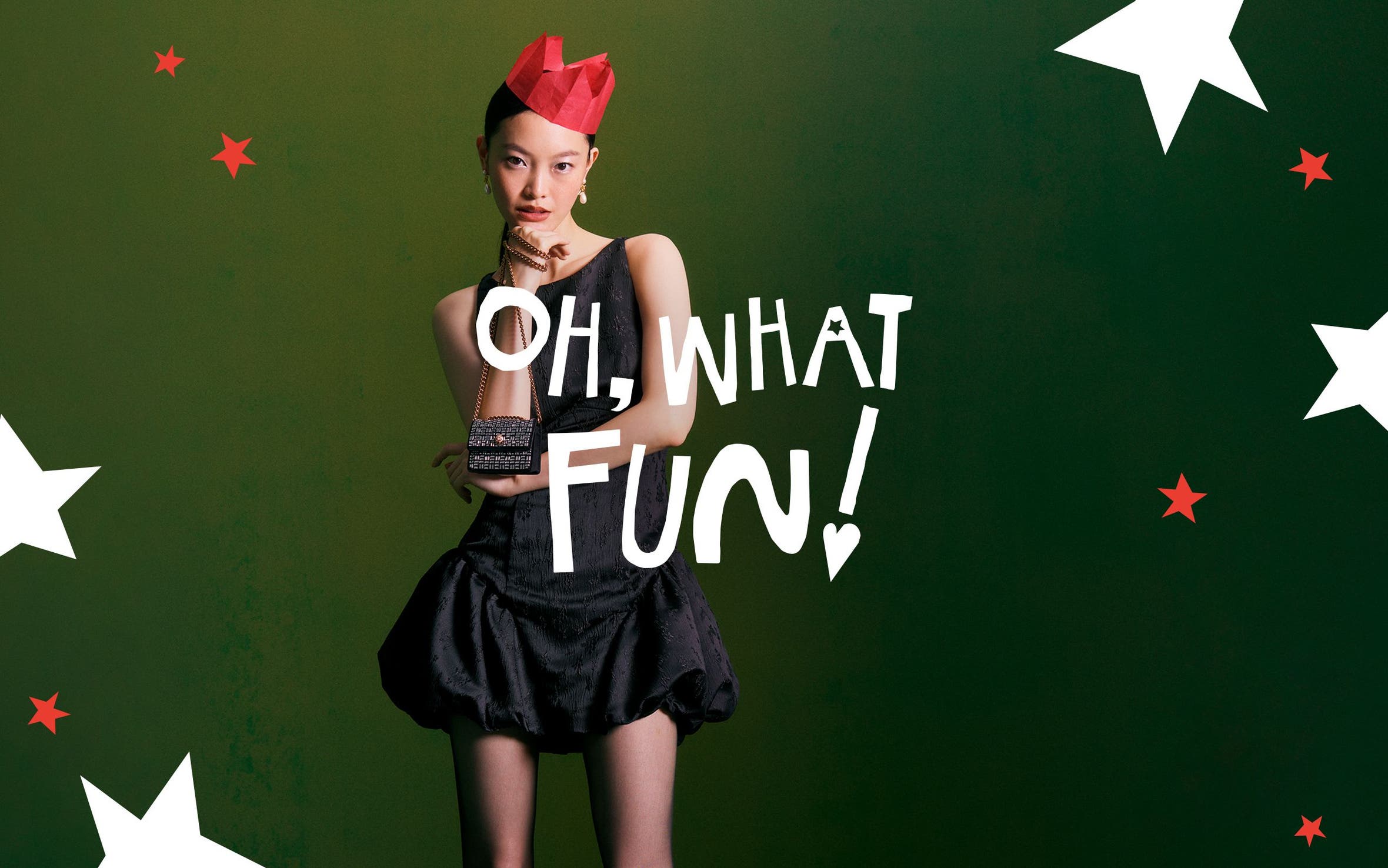 Oh, what fun! A woman wearing a party outfit and a paper crown.