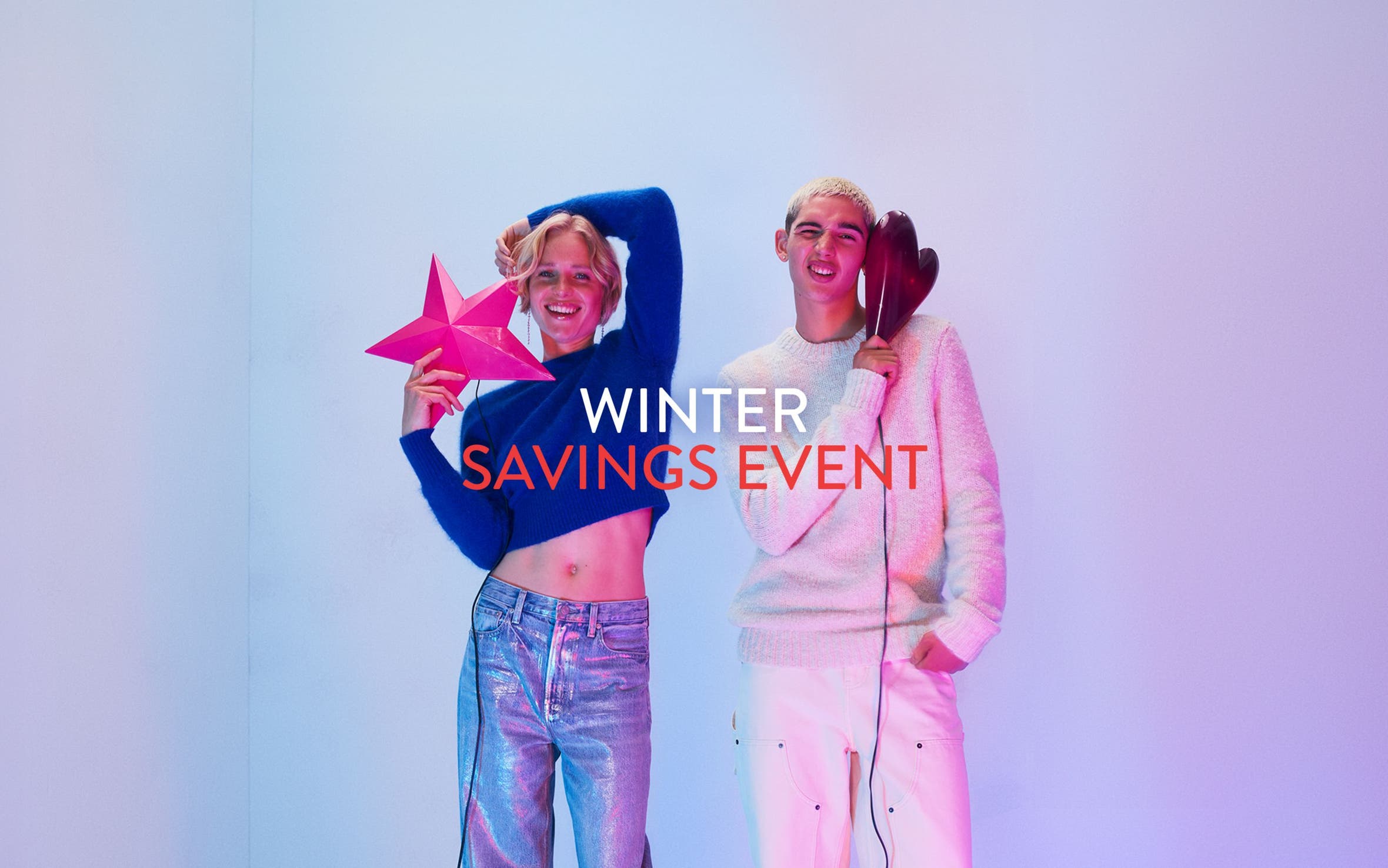 Winter savings event. A woman and man wearing sweaters and jeans.